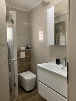 a bathroom with a white sink and a toilet at Anja Apartman in Bosanski Šamac