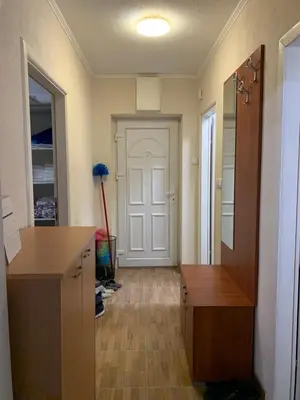 a room with a hallway with a door and a desk at Anja Apartman in Bosanski Šamac