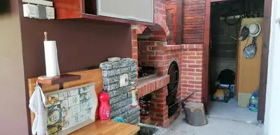 a red brick fireplace with a microwave on top at Pyramid Gardens in Visoko