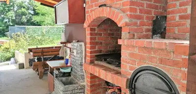 a brick oven with a table in a patio at Pyramid Gardens in Visoko