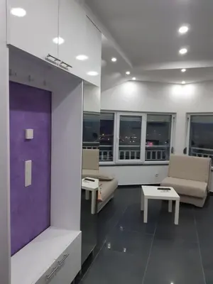 a living room with couches and tables and windows at apartman Dani in Derventa