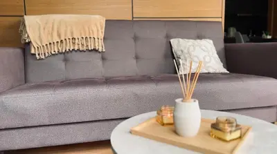 a living room with a couch and a table with candles at Waterfall Glamping Cabin in Bihać