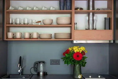 a vase of flowers on a counter in a kitchen at Waterfall Glamping Cabin in Bihać