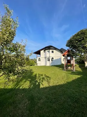 a white house with a large yard in front of it at Villa Sami in Bihać