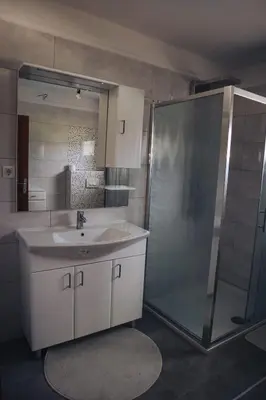 a bathroom with a sink and a shower at Villa Sami in Bihać