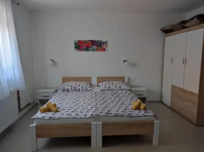 a bedroom with a bed and a painting on the wall at Apartman Markešić 3 in Ripci