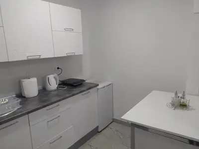 a white kitchen with white cabinets and a sink at Apartman Markešić 3 in Ripci