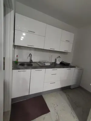 a kitchen with white cabinets and a sink at Apartman Markešić 3 in Ripci