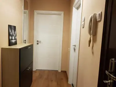 a hallway with a white door and a phone at Apartman Radjenovic in Banja Luka
