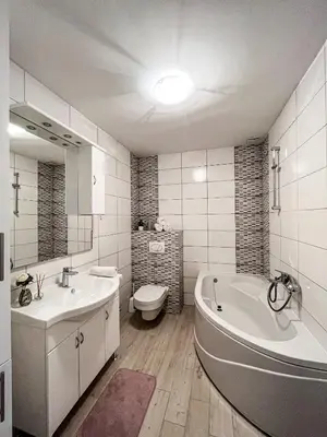 a bathroom with a tub and a sink and a toilet at Apartment Doris in Tomislavgrad