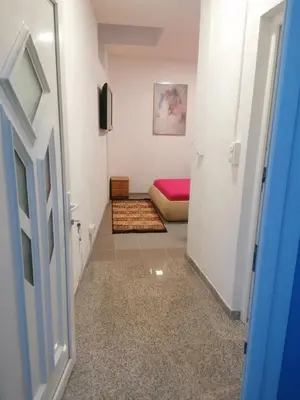 a hallway with a room with a bed and a door at Sphinx Apartment in Visoko