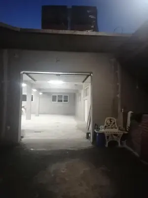 an empty garage with a garage door open at Sphinx Apartment in Visoko