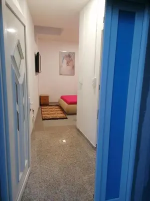 a hallway with a room with a bed and a door at Sphinx Apartment in Visoko