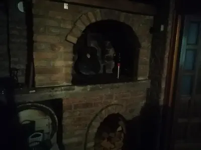 a brick fireplace with a pizza oven in it at Sphinx Apartment in Visoko