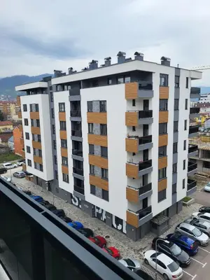 an apartment building with balconies on top of a parking lot at Apartman Paradiso in Banja Luka