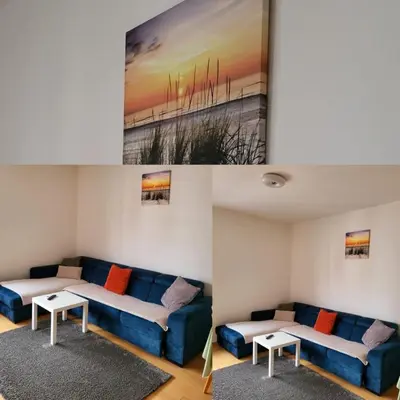 a living room with a blue couch and a table at Apartman Paradiso in Banja Luka