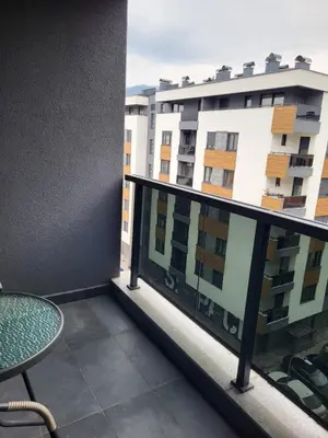 a balcony with a table and a building at Apartman Paradiso in Banja Luka
