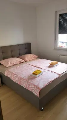 a bed in a room with two pillows on it at Apartman Paradiso in Banja Luka