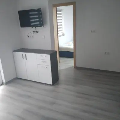 a living room with a tv on the wall at Iva apartmani in Jajce