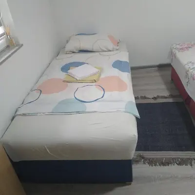 a twin bed with a book and a book at Iva apartmani in Jajce