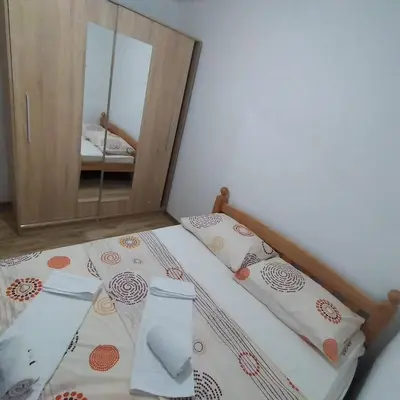 a bedroom with a bed with a mirror at Iva apartmani in Jajce