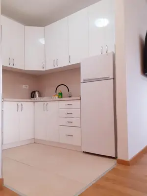 a kitchen with white cabinets and a refrigerator at Apartman kod Brke 20 A Bulevar Vojvode Živojina Mišiča in Banja Luka