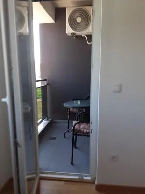 a door leading into a room with a table and a window at Apartman kod Brke 20 A Bulevar Vojvode Živojina Mišiča in Banja Luka
