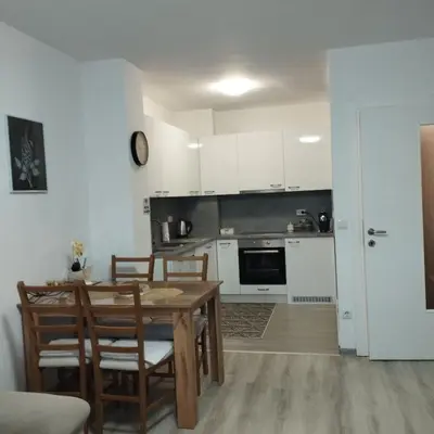a kitchen and dining room with a table and chairs at Little Paradise in Bihać