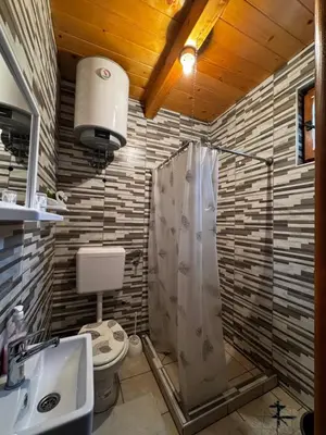 a bathroom with a shower and a toilet and a sink at Apartmani Kajkut in Banja Luka