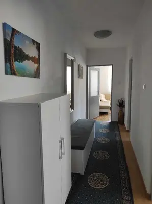 a living room with white cabinets and a couch at Ajsha Guesthouse in Jajce