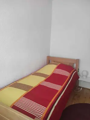 a bed in a room with avertisementatronatronatronstrationstrationstration at Ajsha Guesthouse in Jajce