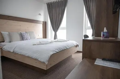 a bedroom with a large bed and a window at Hotel Pilot in Cazin