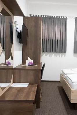 a room with a dining table and a bed at Hotel Pilot in Cazin