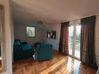 a living room with a couch and a window at Apartman-vikendica Mihajlović in Banja Luka