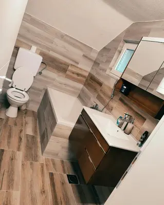 a bathroom with a toilet and a sink at Apartman-vikendica Mihajlović in Banja Luka