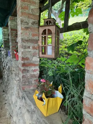 a garden with a bird house and a flower pot at Ravne Konak in Visoko