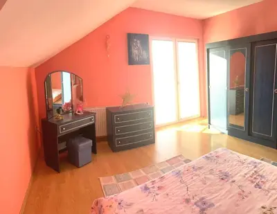 a bedroom with a bed and a dresser and a mirror at Haus mit großen Garten in Modriča