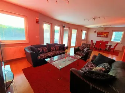 a living room with couches and a glass table at Haus mit großen Garten in Modriča