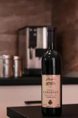 a bottle of wine sitting on top of a counter at Stan na dan Sebastijan in Banja Luka