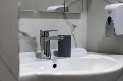 a bathroom sink with a faucet on top of it at Stan na dan Sebastijan in Banja Luka