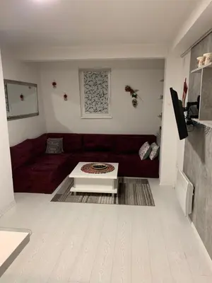 a living room with a red couch and a coffee table at Apartman 