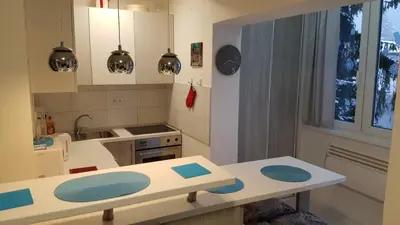 a kitchen with a table and a counter top at Apartman 