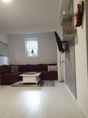 a living room with a couch and a table at Apartman 