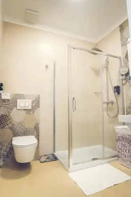 a bathroom with a shower and a toilet at Apartmani SL Luxury in Banja Luka