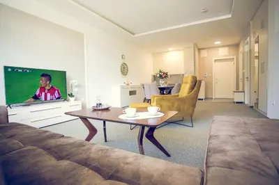 a living room with a couch and a tv at Apartmani SL Luxury in Banja Luka