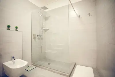 a bathroom with a shower and a toilet and a sink at Apartmani SL Luxury in Banja Luka