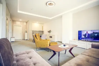 a living room with a couch and a tv at Apartmani SL Luxury in Banja Luka