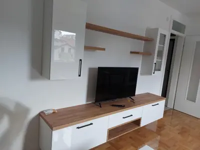a tv on a white cabinet in a room at Zidart lux in Pištelići