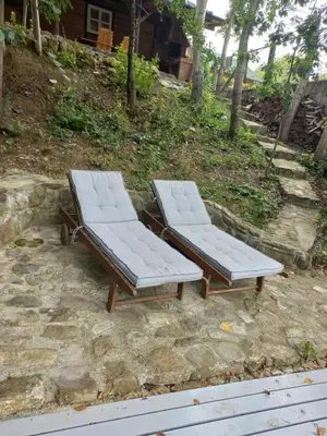two lounge chairs sitting on top of a stone ground at Magaze de Luxe in Gradačac