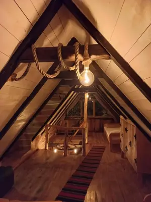 an attic with a light hanging from the ceiling at Magaze de Luxe in Gradačac